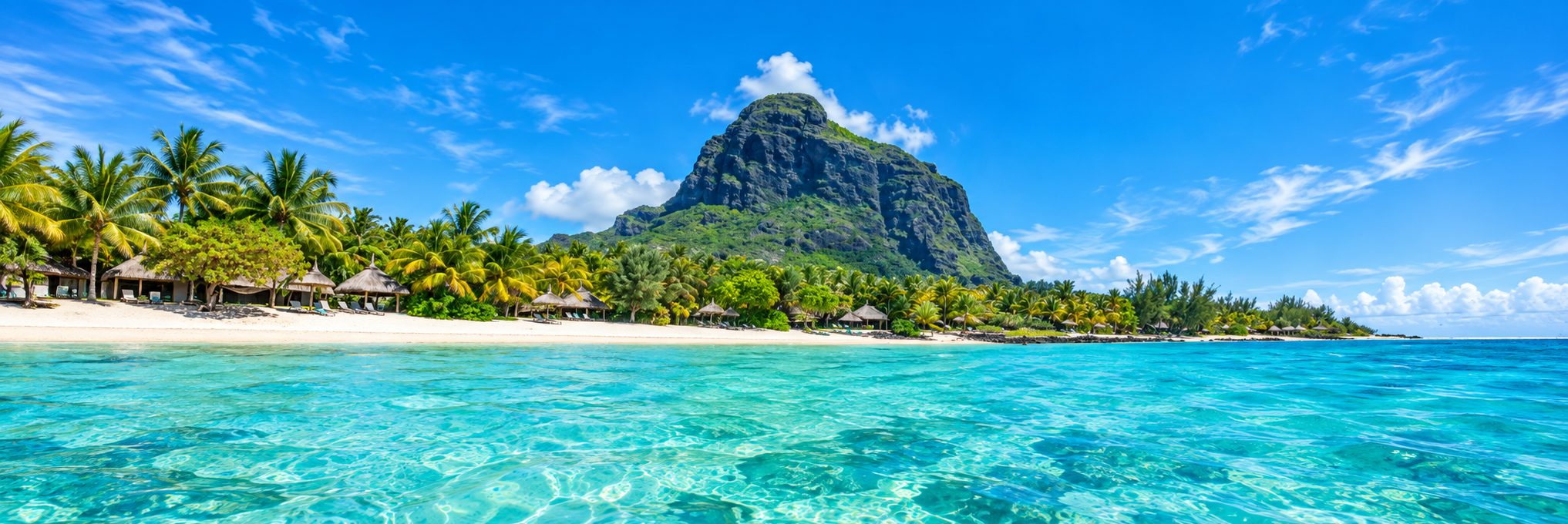 Le Morne mountain rising above a palm-lined beach and turquoise lagoon in Mauritius